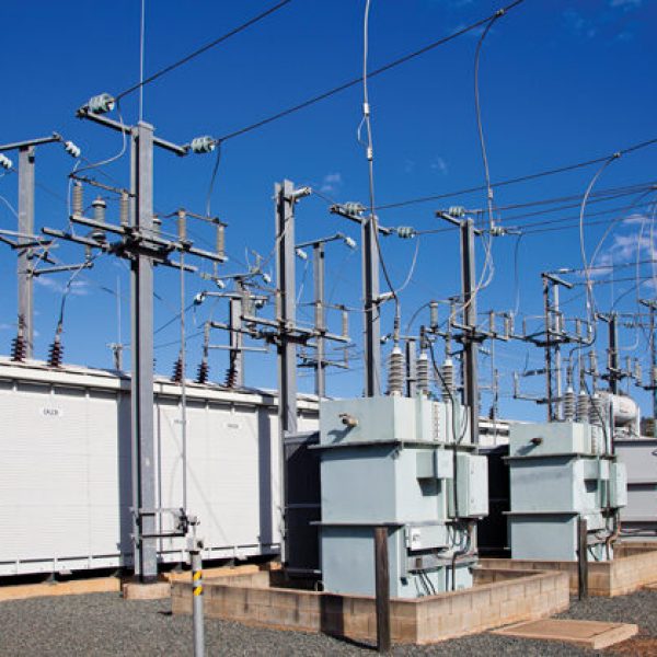 Electrical substation, Pylons and wires distribute power through high voltage trasmission lines. Blue Sky Queensland Australia.